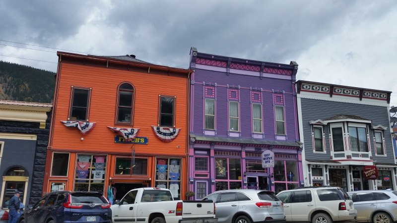 Several colorful old purple and orange shops in Silverton, Colorado, a popular Southwest road trip destination.