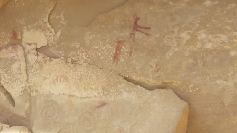 Pictographs of a hand and several human and animal figures from a hiking trail in Chaco Canyon.