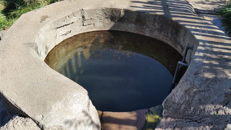 A concrete pool filled with hot spring water.