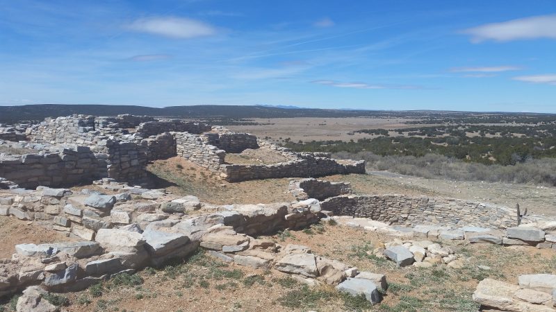 Stone ruins on the plains south of Albuquerque with mountains in the distance.