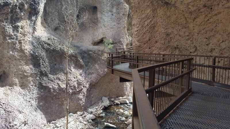 A steel walkway, known as The Catwalk, on the side of a rock face over a creek in Glenwood, New Mexico.