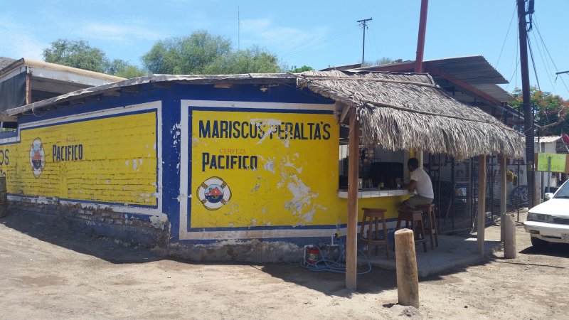 Front of Mariscos Peralta's blue and yellow taco stand, a place popular for Baja California fish tacos in Mulege, Mexico..
