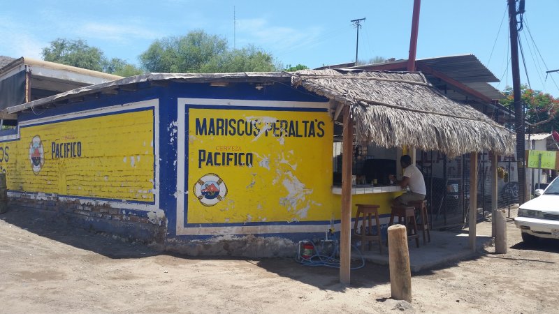 A blue and yellow fish taco restaurant in Baja California.