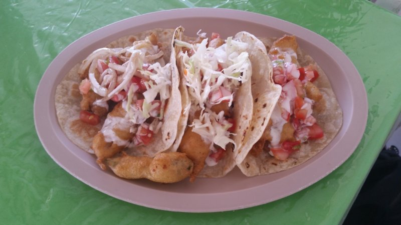 A plate of fish tacos with salsa and slaw on a table at Taqueria El Molontzin in Loreto, Mexico.