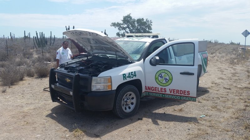 A Green Angels truck with the hood up on the side of the road in Baja Mexico
