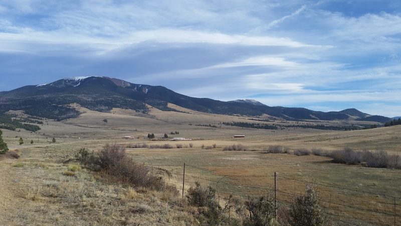 Green, mountains beyond and a vast open valley in the foreground as seen from one of the popular New Mexico scenic drives near Taos.