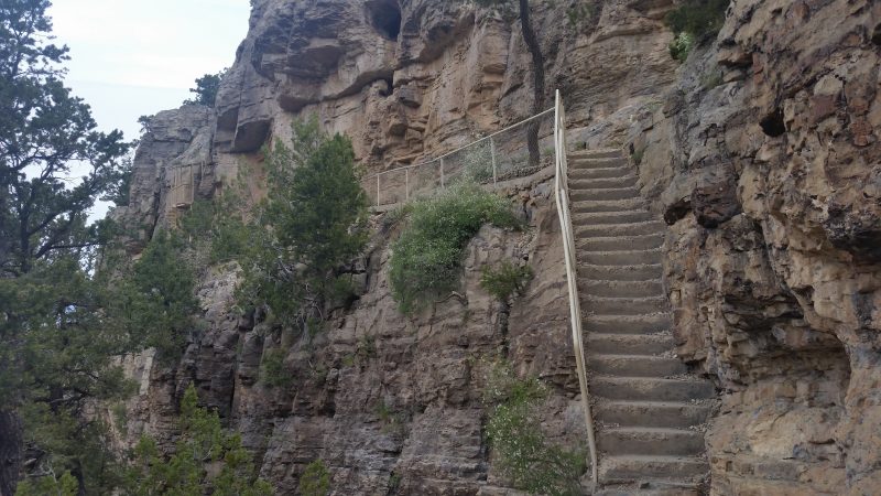 Concrete stairs leading up the side of a cliff at Sandia Man Cave, one of the lesser-known day trips from Albuquerque.