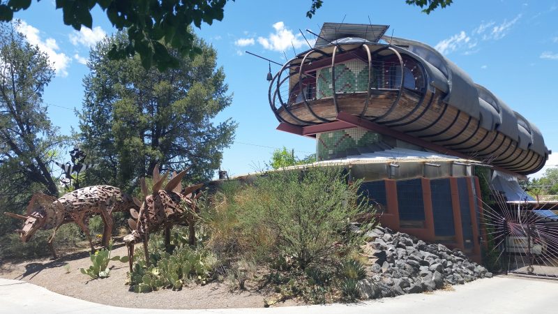 A spaceship-like house with iron dinosaur sculptures in the front yard - one of the lesser-known things to do for free in Albuquerque.