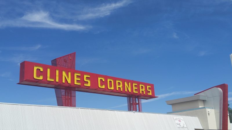 The sign above Clines Corners travel stop near Albuquerque, New Mexico against a blue sky.