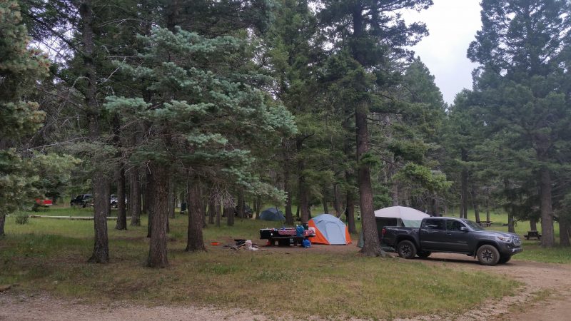 Several tents and a truck at Iron Gate Campground, one the more remote spots for camping near Pecos, NM.
