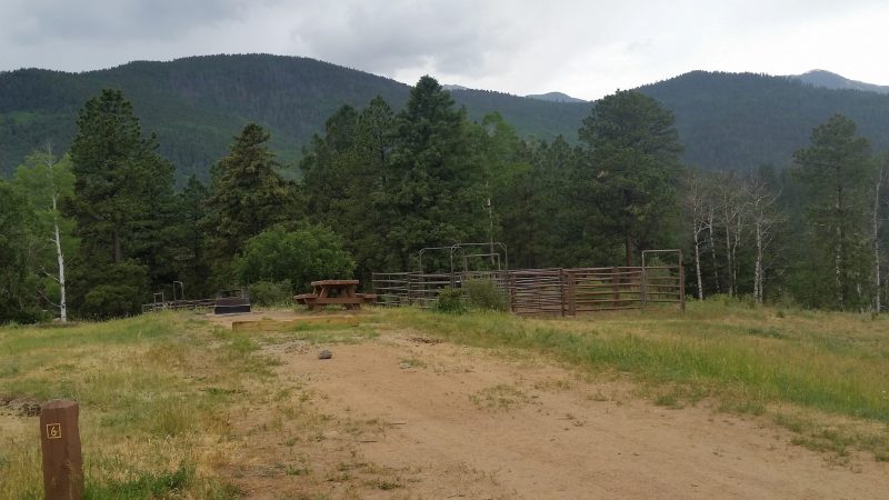A corral and picnic table at Jack's Creek Horse Camp, a spot combining Pecos, NM camping with the opportunity for equestrian trail riding.