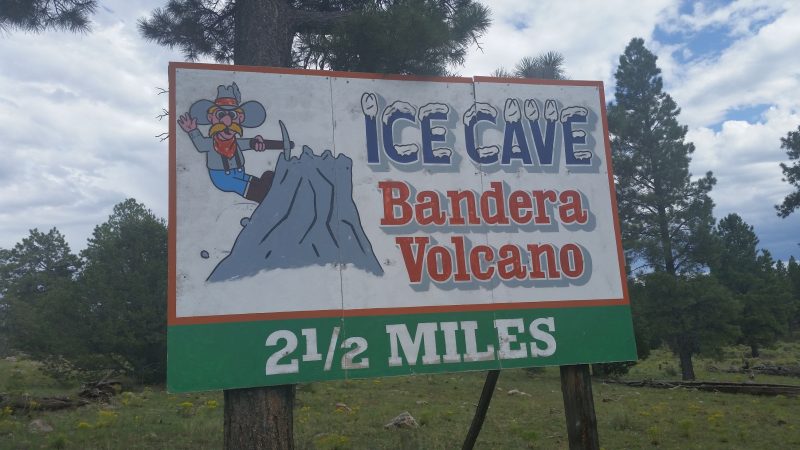 Billboard advertising Bandera Volcano and Ice Caves, a popular road trip destination in New Mexico.