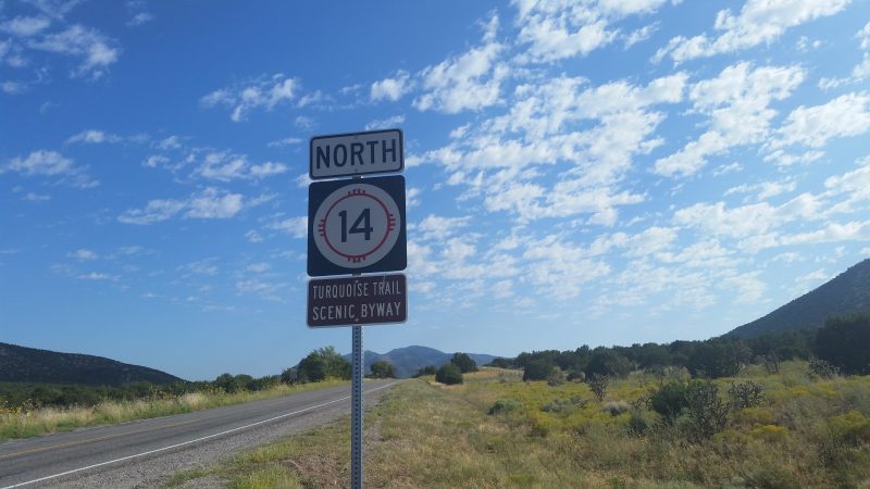 A road sign indicating route 14 north on the Turquoise Trail in New Mexico.