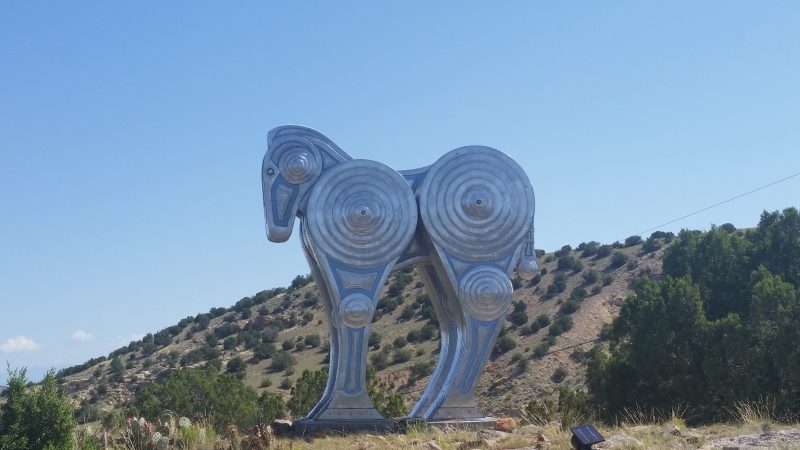 A stylized silver steel horse on the side of the Turquoise Trail in New Mexico.
