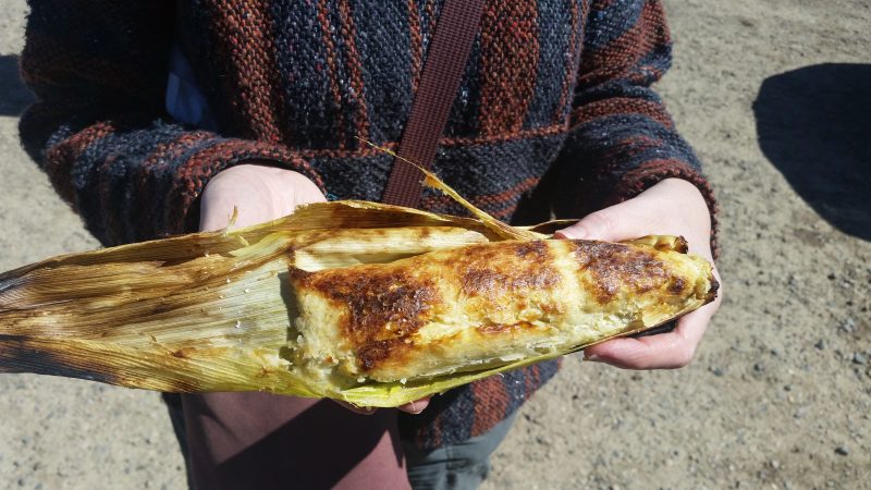 A woman holding an example of Navajo Kneel Down Bread at the Gallup 9th Street Flea Market in New Mexico.