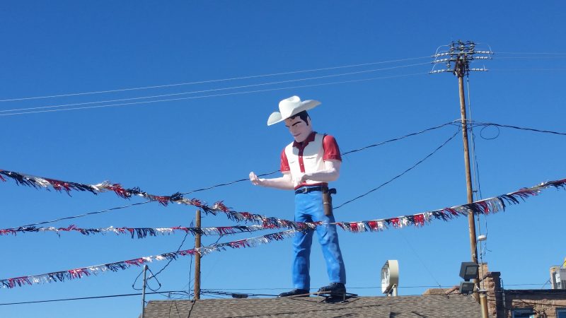 Fibreglass Muffler Man wearing a cowboy hat and gun holster in Gallup, New Mexico a.k.a as Dude Man.