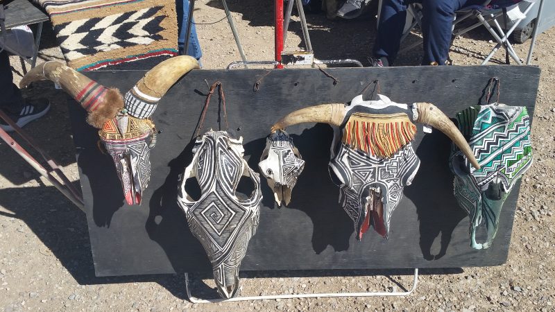Painted cattle and sheep skulls with intricate black and white geometric designs from a Navajo flea market in Gallup, New Mexico.