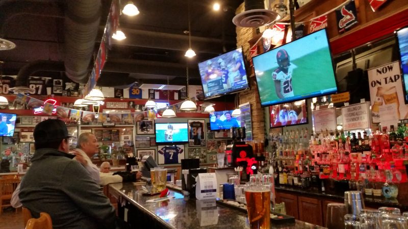 A sports bar and restaurant in Gallup, NM with televisions and memorabilia hanging from the walls.