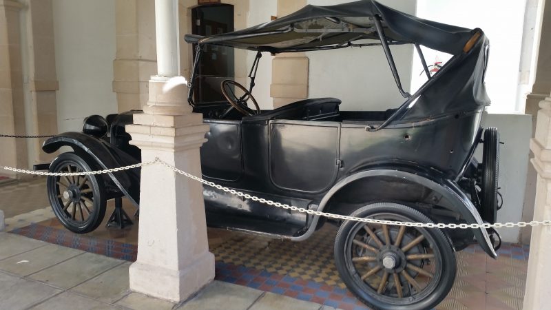 The black 1922 Dodge car in which Pancho Villa was killed in with several bullet holes visible located inside the Museum of the Mexican Revolution in Chihuahua, one of the off the beaten path places in Mexico to visit.