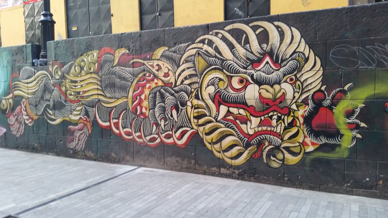 A painting on the side of a wall in Mexico City depicting a Chinese dragon.