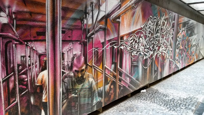 A colorful mural from the Garibaldi/Lagunilla Metro Station in Mexico City depicting a man riding the Metro.