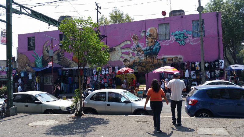  Mexico's City's street art features plenty of buildings like this purple one painted with an image of a skeleton wearing a suit and smoking a cigar on its side.