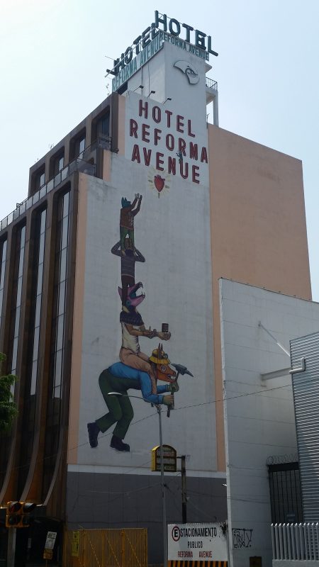 The side of a hotel in Mexico City painted with a mural.