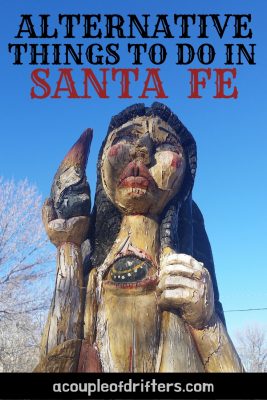 A carved wooden angel in Santa Fe New Mexico against a blue sky.