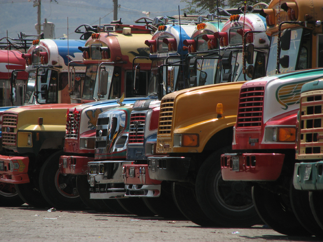 A row of brightly-colored chicken buses somewhere in Guatemala.
