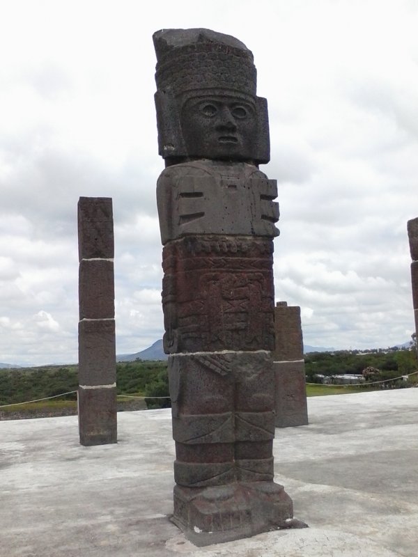 Tall stone Atlantean figure atop a pyramid in Tula, Mexico.