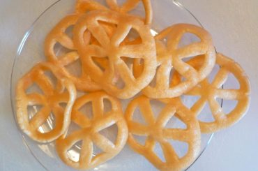 A glass plate of pinwheel-shaped snacks.