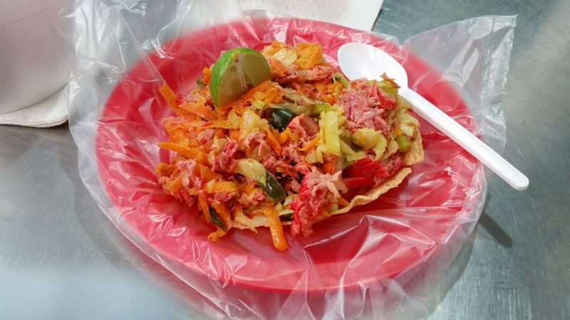 A smoked marlin tostada from a vendor in Mexico selling authentic local street food.